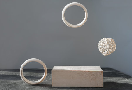 minimal style wooden podium or pedestal for product presentation. wooden display and flying rings...