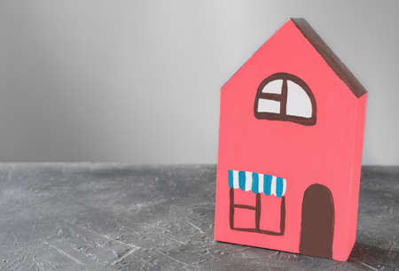 hand made toy wooden house. red house painted by kids. real estate and mortgage concept. rent housing, copy space for textの写真素材