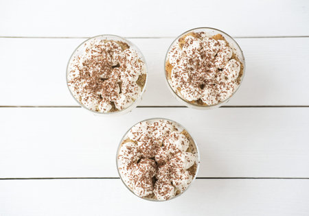 Tiramisu cakes in glass, classic Italian dessert made of cookies savoiardi, mascarpone cream and...