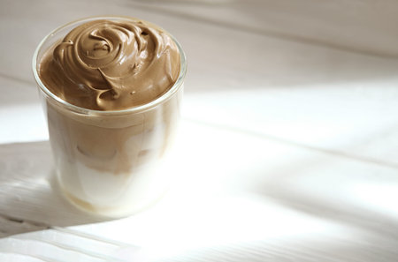 Iced frothy Dalgona Coffee, a trendy fluffy creamy whipped coffee. Korean drink latte espresso with coffee foam. made of instant coffee, sugar, hot water and milk.の写真素材