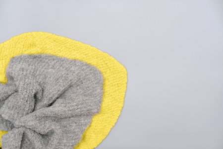 knitted scarves in trendy colors of the 2021 illuminating yellow and ultimate gray. Gray and yellow winter acsessories.の写真素材