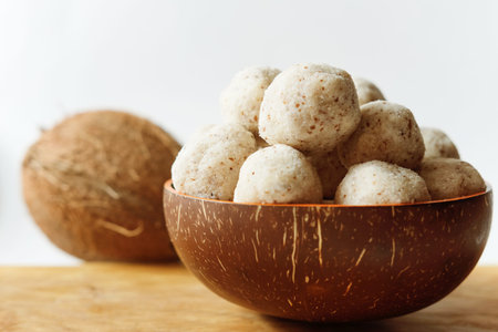 homemade coconut energy balls with almond in natural coconut bowl. healthy sugar free concept. keto diet recipe.の写真素材