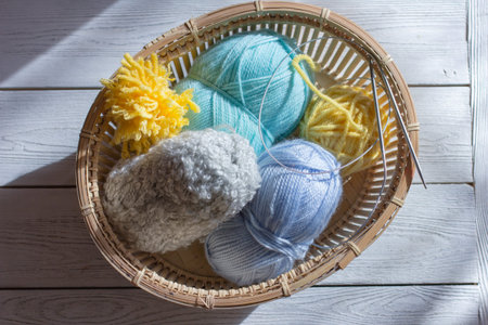 knitting yarn, needles, skeins of yarn. spring colors for knitting. turquoise, gray and yellow yarn...