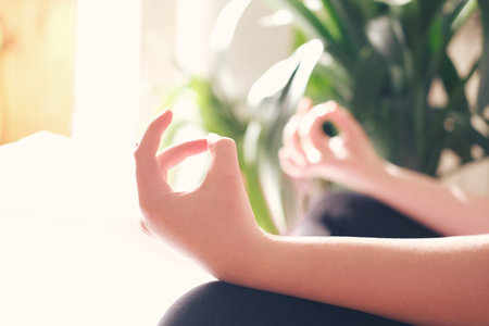cropped teenage girl or young woman practicing yoga lesson, breathing, meditating,の写真素材