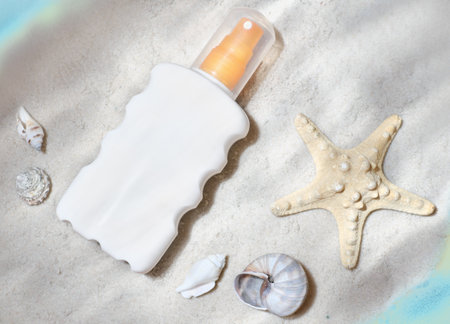 sunscreen lotion under the sea water. starfish and seashells on the sand. suntan cream. summer cosmetics. SPF protection UV sunlight shield. skin care in the summer.の写真素材