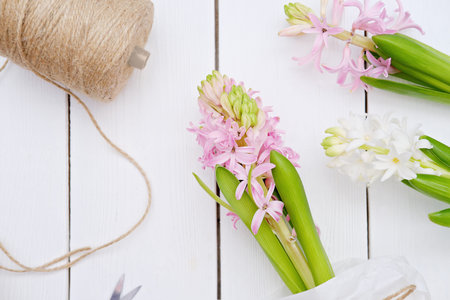 hyacinth flowers on the table in florist shop. biodegradable natural packaging matherials. easter...