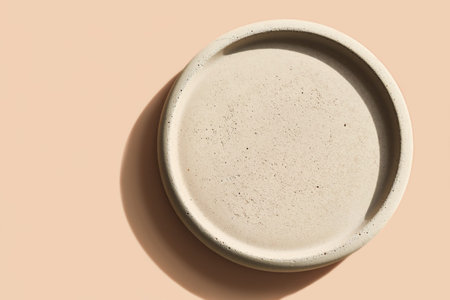 Beige plate on a beige background. concrete plate mock up. monochrome image. template for product...