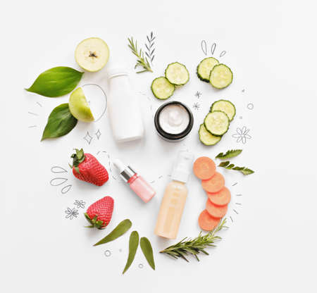 organic cosmetics with eatable ingredients. cucumber, carrot and strawberry as cream and serum components. home grown cosmetics. flat lay.の写真素材