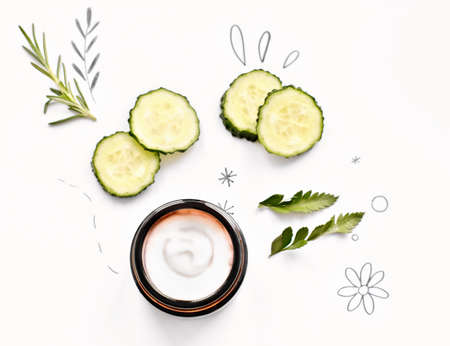 cucumber and rosemary face care mask on white background. natural organic cosmetics ingredients. cream in glass jar. top view.の写真素材