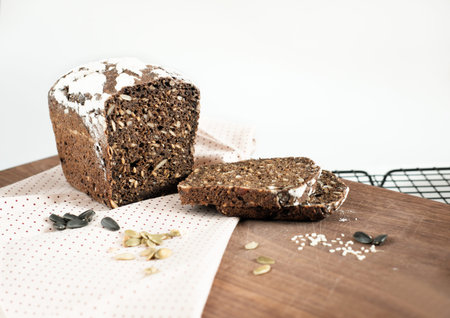 Homemade gluten free buckwheat bread with various seeds on a rack. fresh baked low carb bread...