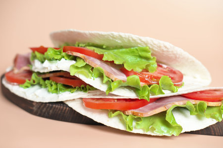 Italian street food. piadina with ham, cheese and tomatoes close-up view. piada made of tortillas...