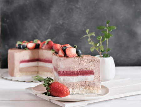 a piece of cake with mousse filling and strawberry jelly. low sugar homemade cake.