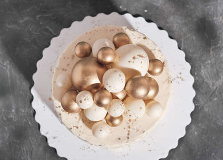 wedding cake decorated with golden balls. Luxury decorated cake for anniversary, birthday Celebration concept, Festive dessert. top view.の写真素材