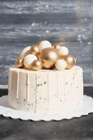 wedding cake decorated with golden balls. Luxury decorated cake for anniversary, birthday Celebration concept, Festive dessert for new year party.の写真素材