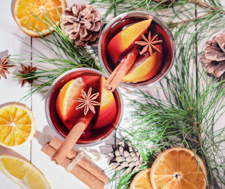 hot mulled wine glasses with oranges, cinnamon and anise stars. christmas flat lay, top view. holiday warm drinks, cozy winter time for family.の写真素材