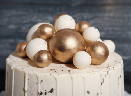 wedding cake decorated with golden balls. Luxury decorated cake for anniversary, birthday...