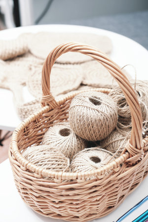 jute crochet balls and bobbins of threads in a basket on table. hobby and handcraft. eco materials...