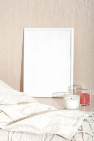 white empty frame for text , white and red soy wax candles and canvas plaid. eco natural home...
