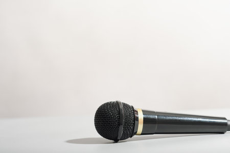 black microphone over gray background. copyspace. media broadcast concept.の写真素材