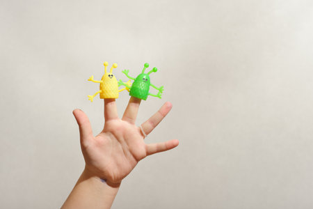 two fingers wearing puppets aliens. Kid playing fingers puppets. Finger theater for children.の写真素材
