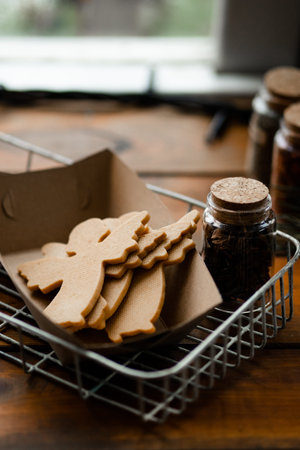 Winter mood. Close up view of the tasty cookies of shape of the christmas angels laying at the craft...