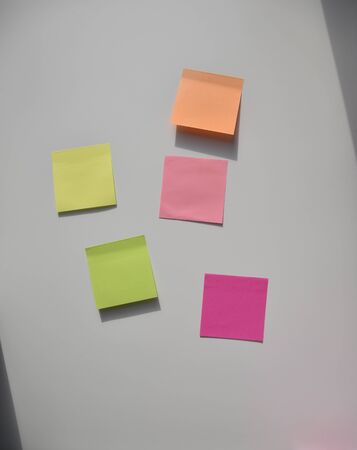 yellow, pink, orange, green stickers on the white boardの写真素材
