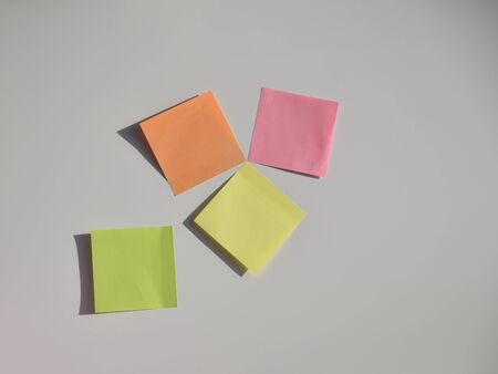 yellow, pink, orange, green stickers on the white boardの写真素材