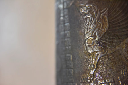 one side of an old cooper bottle with a griffon image on it