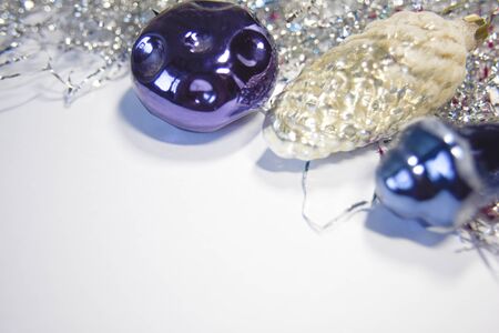 Old christmas and new year toys made of glass on the white backgtound. Image with empty space for text as a concept of Christmas cards or invitations.の写真素材