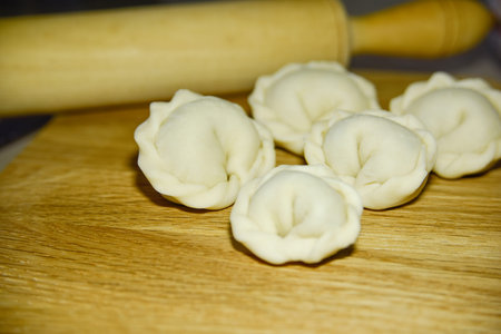 Five dumplings of round shape on the wooden deck.