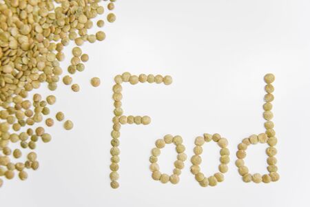 Word Food assembled with grains of lentil on the whiteの写真素材