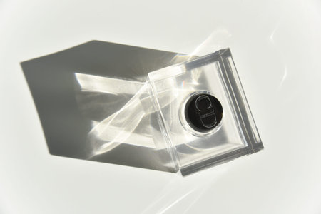 the bottle of Christian Dior Homme perfume with the sunlight going through and making light effects...