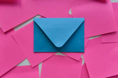 selective focus, single blue envelope in the middle of pink stickersの写真素材