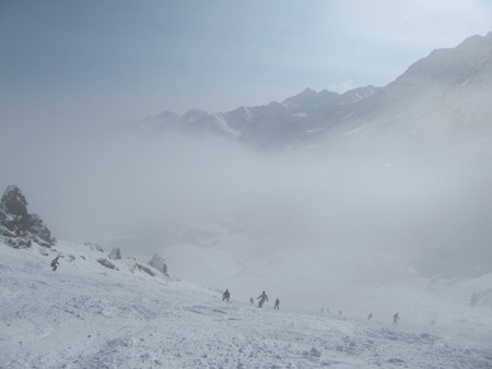 Skiers and snowboarders down the ski slope in a heavy fog, which is very dangerousの写真素材