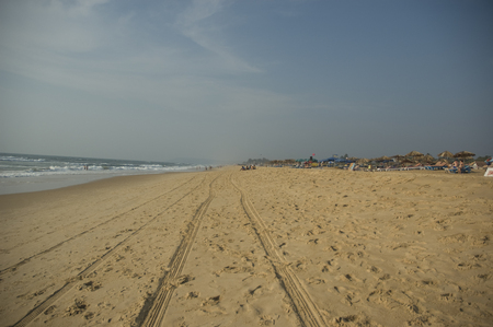 Traces of car wheels on the beach in India.の写真素材