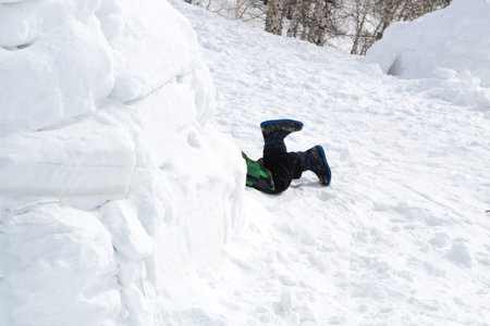 Legs sticking out of the entrance to the snow house-Igloo.