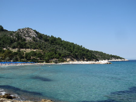 The Island Of Thassos, Greece. The most beautiful beach in Greece with a blue flag. Tourists enjoy a good day at the beach.の写真素材
