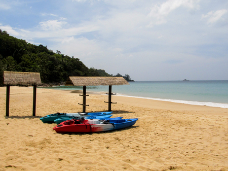 Colorful canoe lie on a beautiful tropical beach and wait for touristsの写真素材