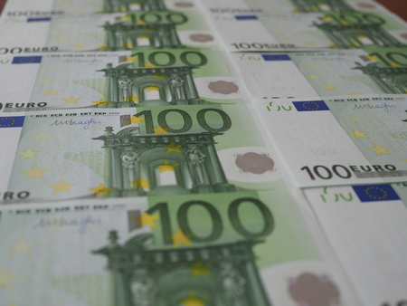 Many new 100 Euro banknotes are neatly arranged in rowsの写真素材