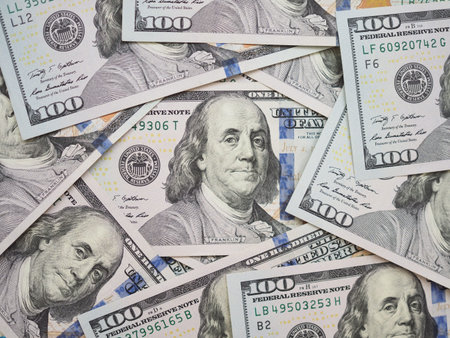 100 dollar bill surrouded by new 100 dollar bills.