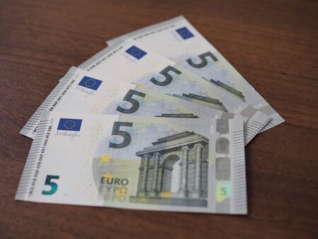 A lot of bills in a five euros spread out on the table fan.の写真素材