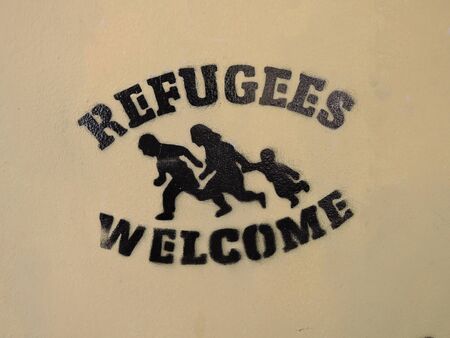 Graffiti on the wall in the center of Greece. Refugees are welcomeの写真素材