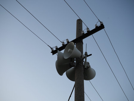 Electric poles and megaphone with blue sky background
