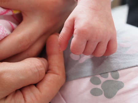 newborn baby pen on her mother's hand close-up.