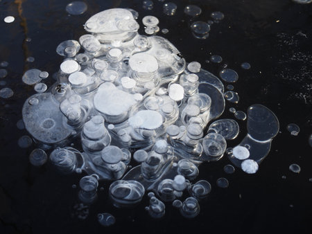 Air bubbles trapped in frozen water at Lake Baikal, Siberia, Russia.