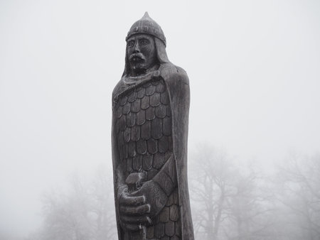 wooden sculpture of a knight is covered with frost in a misty forest. Russia, Saratov - november,...