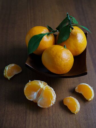 beautiful still life with ripe tangerines with green leaves in vertical format for social media.の写真素材