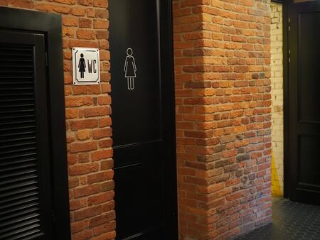 Toilet icons set. Men and women WC signs for restroom.Restroom sign on a toilet wall,on modern background.Toilet sign - Restroom Concept - black toneの写真素材