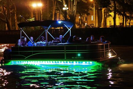 Night in Tbilisi at Mtkvari River, Speed Boat Passing. ourists on Board enjoy the beautiful views.のeditorial素材