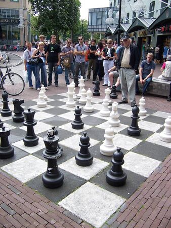 People playing chess on the street with oversized pieces. It is favourite leisure of local men.のeditorial素材